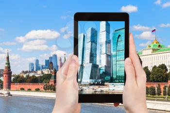 travel concept - tourist photographs picture of Moscow City towers on tablet pc