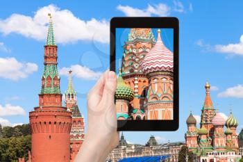 travel concept - tourist photographs picture of Saint Basil Cathedral in Moscow on tablet pc