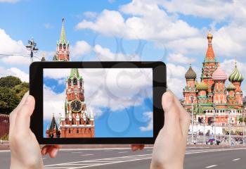 travel concept - tourist photographs picture of Spasskaya Tower of Moscow Kremlin from Bolshoy Moskvoretsky bridge on tablet pc