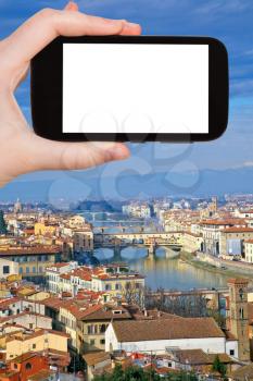 travel concept - hand holds smartphone with cut out screen and Florence cityscape on background