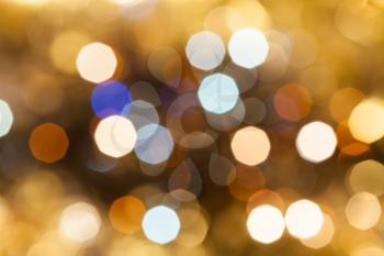 abstract blurred background - blue, pink, brown shimmering Christmas lights bokeh of electric garlands on Xmas tree