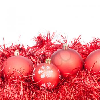 few red Xtmas balls and tinsel isolated on white background
