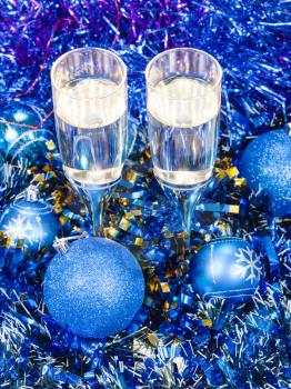 Christmas still life - above view of two glasses of sparkling wine in blue Xmas decorations