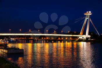 travel to Bratislava city - night illumination of Danube river from Most SNP (Bridge of the Slovak National Uprising, UFO Bridge, Novy most, New Bridge) in Bratislava