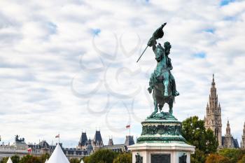 travel to Vienna city - statue of Archduke Charles on Heldenplatz square and view of Rathaus in Vienna, Austria