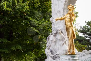 travel to Vienna city - gilded bronze statue Waltz King Johann Strauss son in Stadtpark (City Park), Vienna, Austria