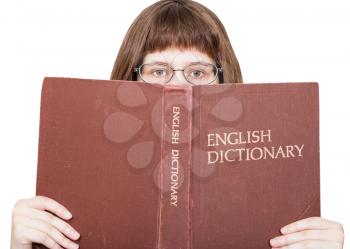 girl with glasses looks over English Dictionary book isolated on white background