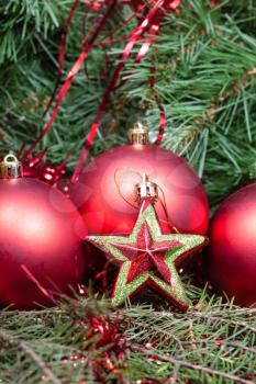 vertical Christmas still life - red star, Christmas balls on Xmas tree background