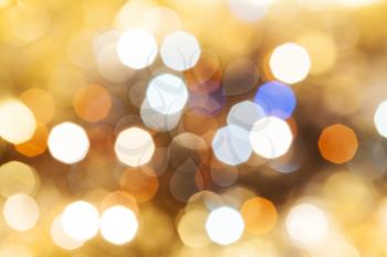abstract blurred background - blue and brown shimmering Christmas lights bokeh of electric garlands on Xmas tree