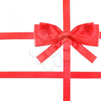 one red satin bow in upper right corner and three intersecting ribbons isolated on square white background