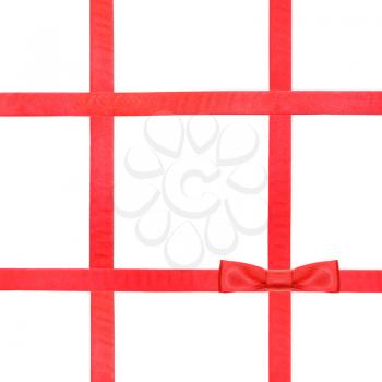 one red satin bow knot in lower right corner and four intersecting ribbons isolated on square white background