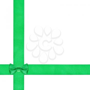 one little bow knot on two crossing silk ribbons isolated on white background