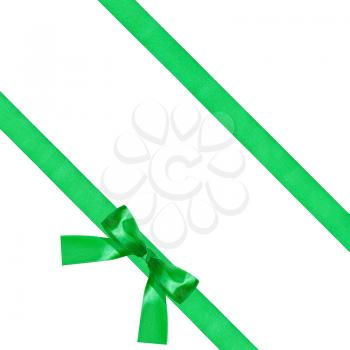big green bow knot on two diagonal satin ribbons isolated on white background
