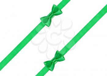 two green bow knots on two diagonal satin strips isolated on white background