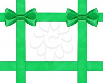 two big green bow knots on four satin ribbons isolated on white background