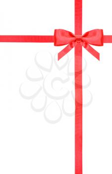 one red satin bow in upper right corner and two intersecting ribbons isolated on vertical white background