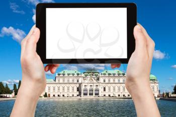 travel concept - tourist photographs Upper Belvedere Palace in Vienna on tablet pc with cut out screen with blank place for advertising logo