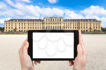 travel concept - tourist photographs of Schloss Schonbrunn palace in Vienna on tablet pc with cut out screen with blank place for advertising logo