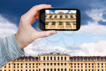 travel concept - tourist snapshot of facade Schloss Schonbrunn palace in Vienna on smartphone