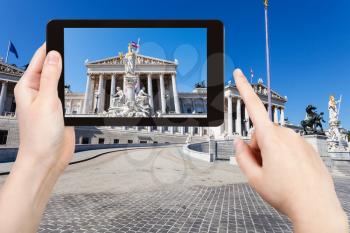 travel concept - tourist snapshot of Pallas Athena Fountain and Austrian Parliament Building in Vienna on tablet pc