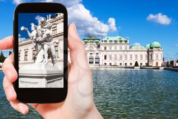 travel concept - tourist snapshot of sculpture near Upper Belvedere Palace in Vienna on smartphone