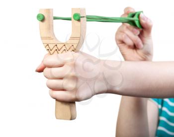 girl shoots from simple wooden slingshot isolated on white background
