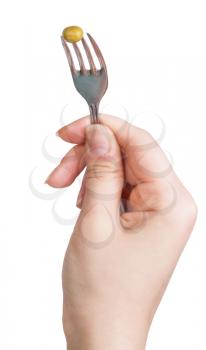 green pea seed impaled on fork in female hand isolated on white background