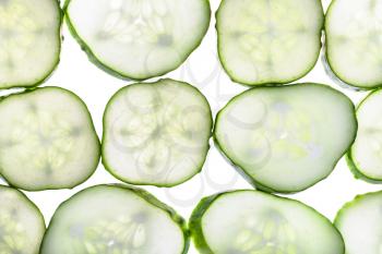 rows from slices of fresh cucumber isolated on white background