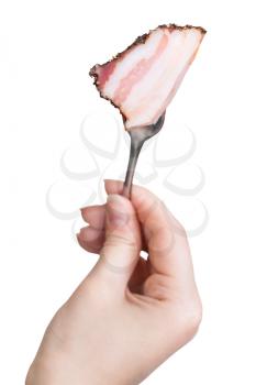dinning fork with impaled piece of bacon in hand isolated on white background