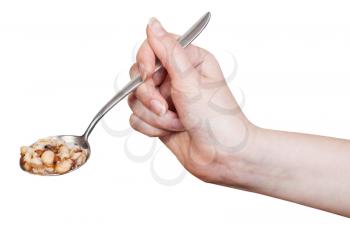 hand holding spoon with beans soup isolated on white background