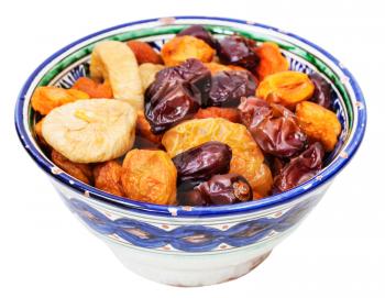Central Asian dried fruits in typical ceramic bowl isolated on white background