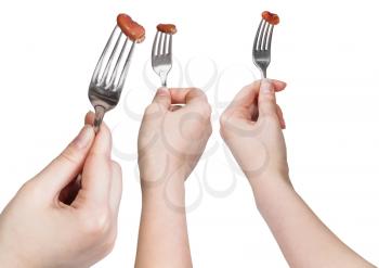 set of dinning forks with impaled brown bean isolated on white background