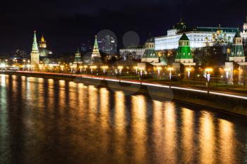 night cityscape with Kremlin embankment and Moskva River in Moscow