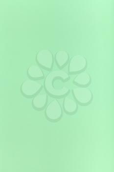 vertical background from light green colored sheet of paper