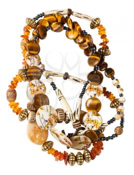 tangled necklace from natural amber, tiger's eye, bone, nacre, agate beads isolated on white background