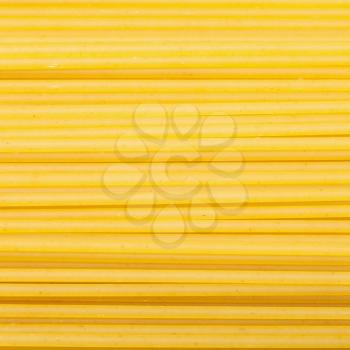 square food background - durum wheat semolina pasta spaghetti close up