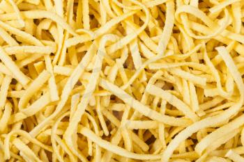 food background - many durum wheat semolina homemade egg pasta taglierini