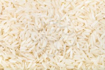food background - long grains of uncooked white jasmine rice