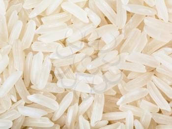 food background - long-grain uncooked white jasmine rice close up