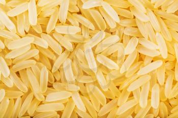 food background - yellow parboiled long grain Indica rice close up