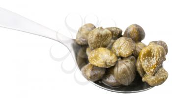pickled capers in spoon close up isolated on white background