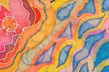 textile background - yellow, red, blue abstract hand painted ornament on silk batik
