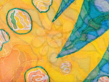 textile background - yellow and green abstract hand painted ornament on silk batik