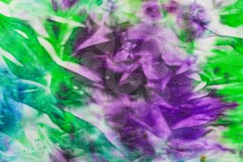 textile background - abstract hand painted green and lilac nodular batik