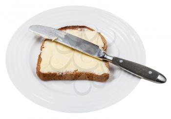 rye bread and butter sandwich with table knife on white plate isolated on white background