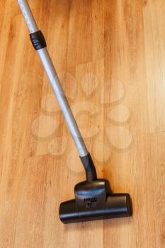 sweeping of laminate floor by vacuum cleaner at home