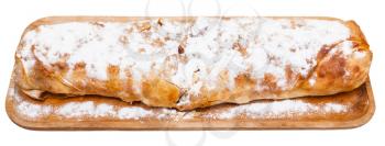 whole traditional viennese apple strudel on wooden board isolated on white background