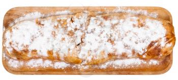 above view of baked apple strudel pie on wooden board isolated on white background