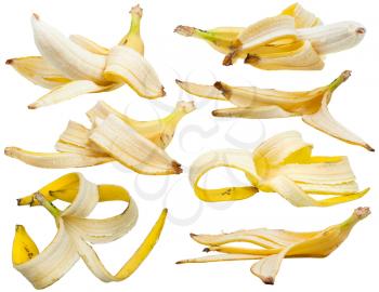 many peeled yellow bananas and banana peels isolated on white background