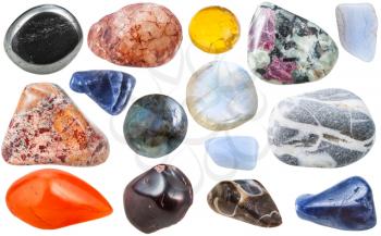 macro shooting of collection natural stones - many tumbled ornamental gem stones isolated on white background